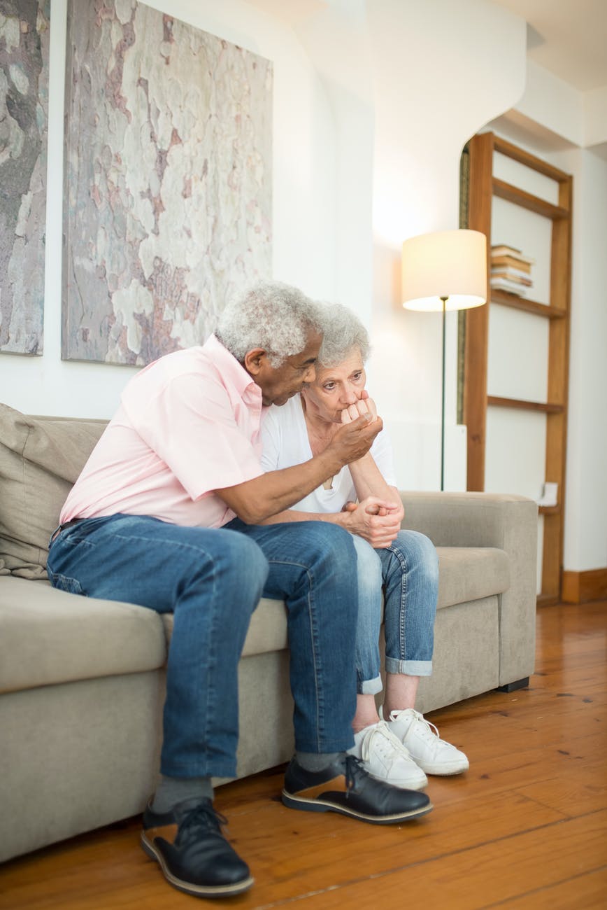 elderly couple sitting on sofa
