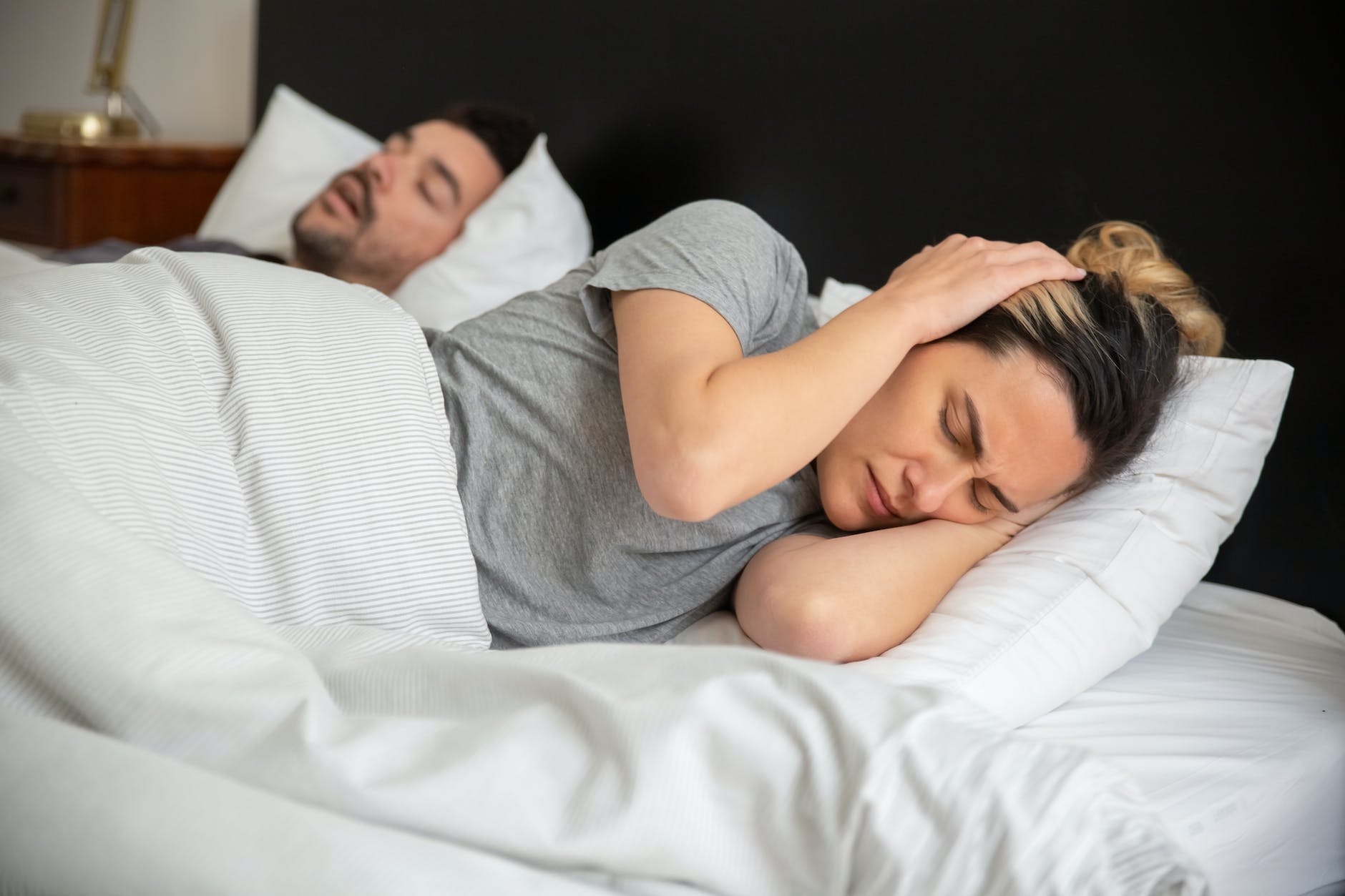 a frustrated woman trying to sleep