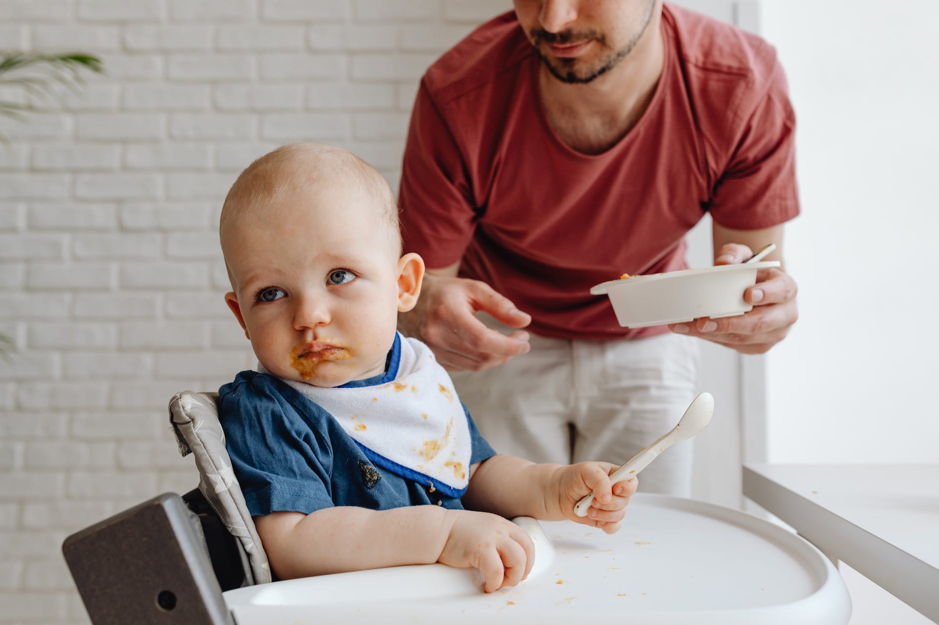 photo of a man feeding a child