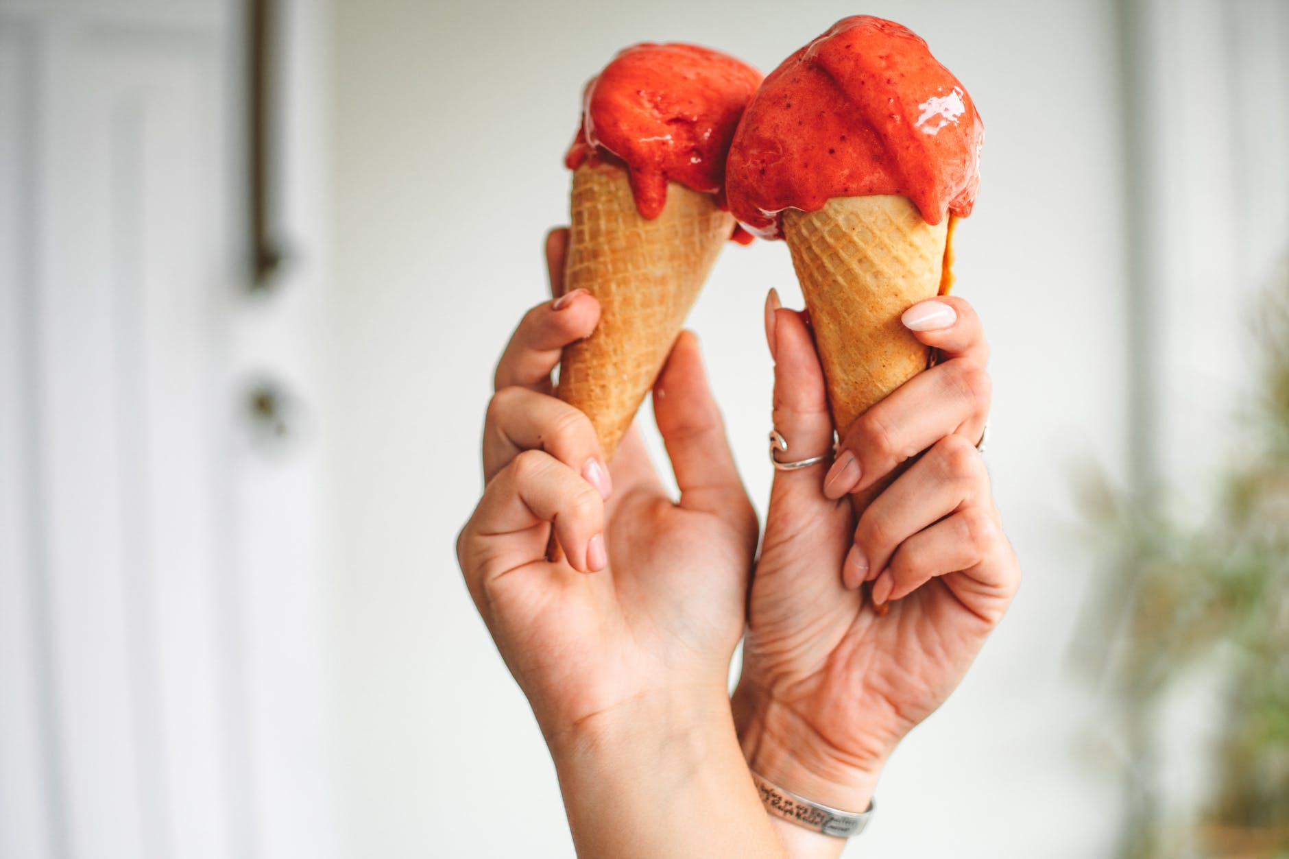 a person holding gelato on cones