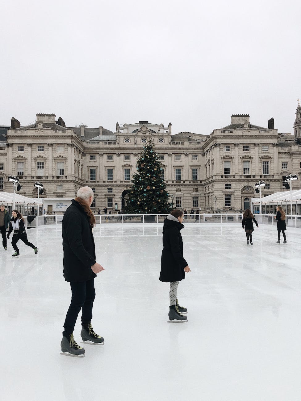 man and woman ice skating