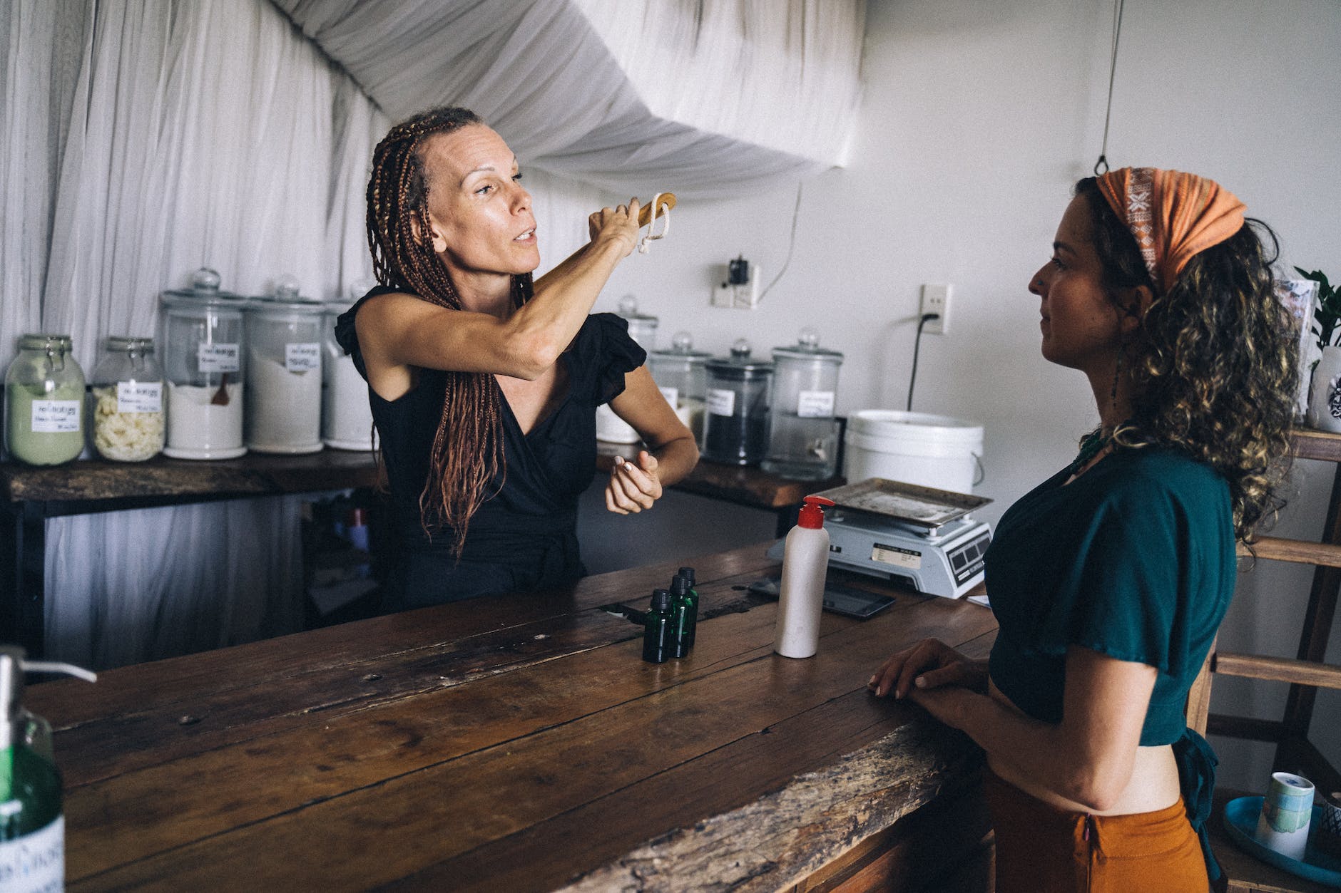 saleswoman of a shop with eco friendly products talking to a customer